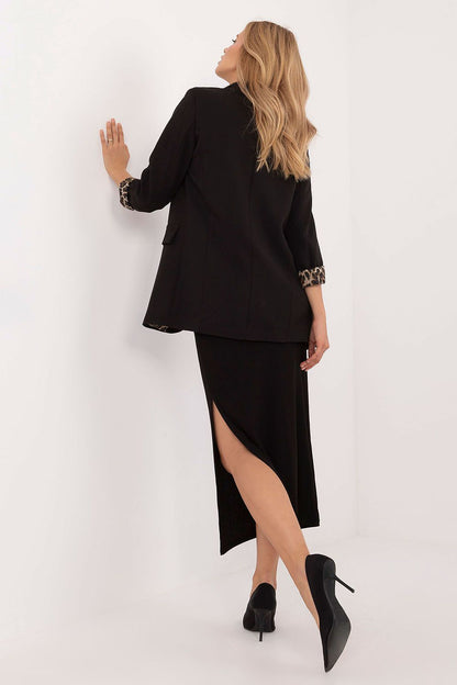 Sophisticated close-up of Italy Moda's pencil midi skirt, showcasing the fine ribbed texture and stylish slit design for a touch of luxury.