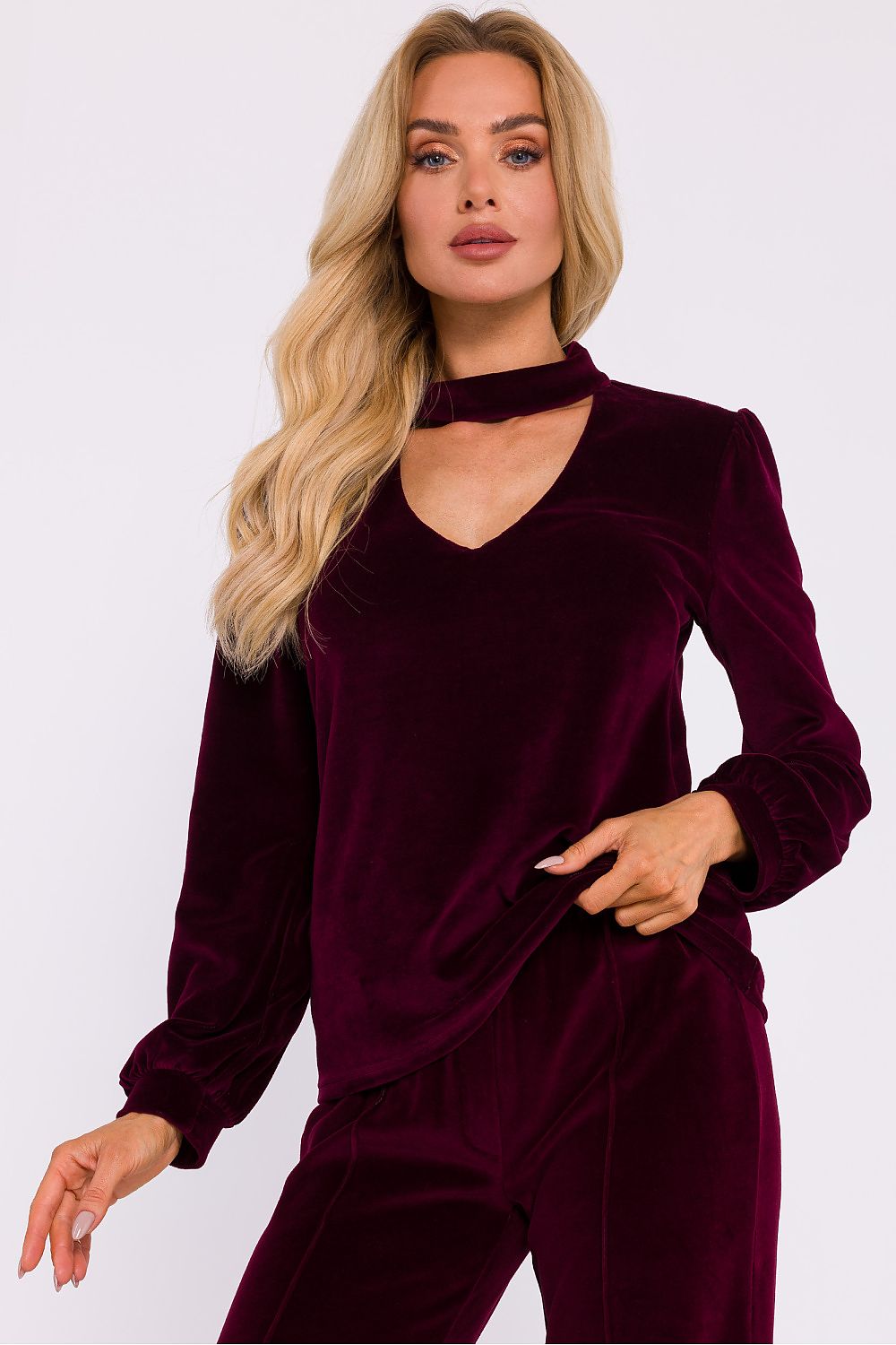 Model wearing the elegant velour blouse by Moe, styled for a chic evening outfit with long wide sleeves.