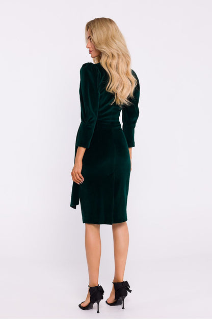 Side view of an elegant velour knit dress by Moe, highlighting the stylish high slit and feminine form.