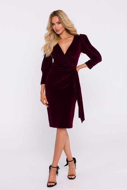 Chic knee-length pencil dress by Moe in soft velour, showcasing 7/8 length sleeves and decorative sash for a refined silhouette.