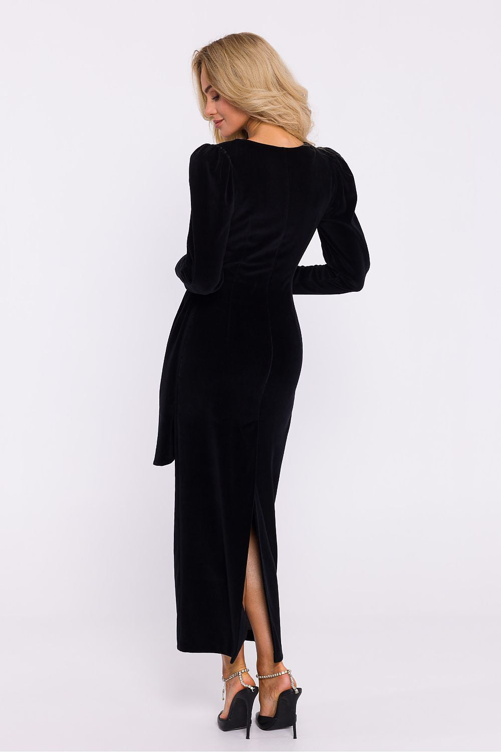 Side view of the Elegant Velour Knit Long Dress by Moe, highlighting the decorative sash and 7/8-length sleeves for an elegant evening look.