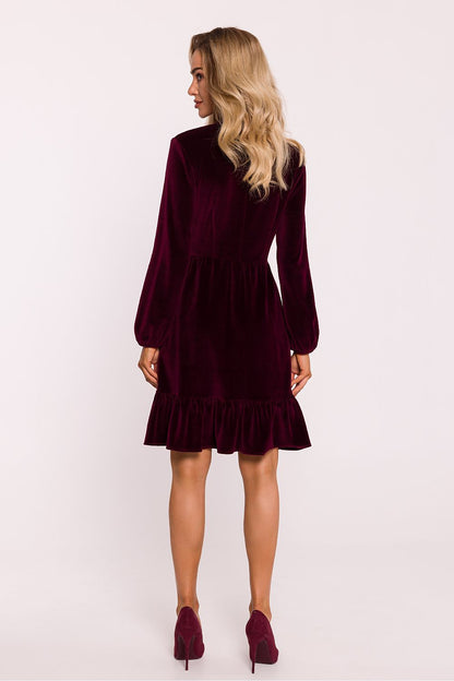 Luxurious velour knit dress by Moe showcasing an emphasized waist and romantic buffet sleeves for a sophisticated look.