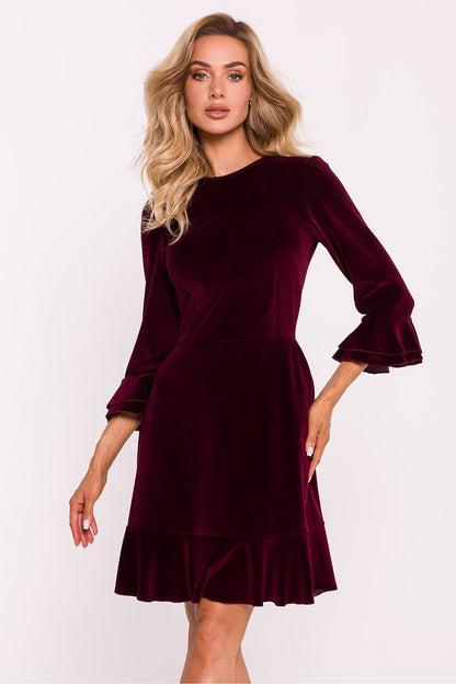 Close-up of the ruffled sleeves and neckline of the Moe elegant daydress, showcasing the luxurious velour knit fabric.