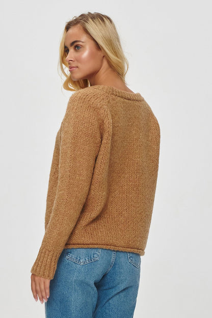 Comfortable Makadamia sweater with a slightly lowered shoulder line, designed for warmth and versatility.