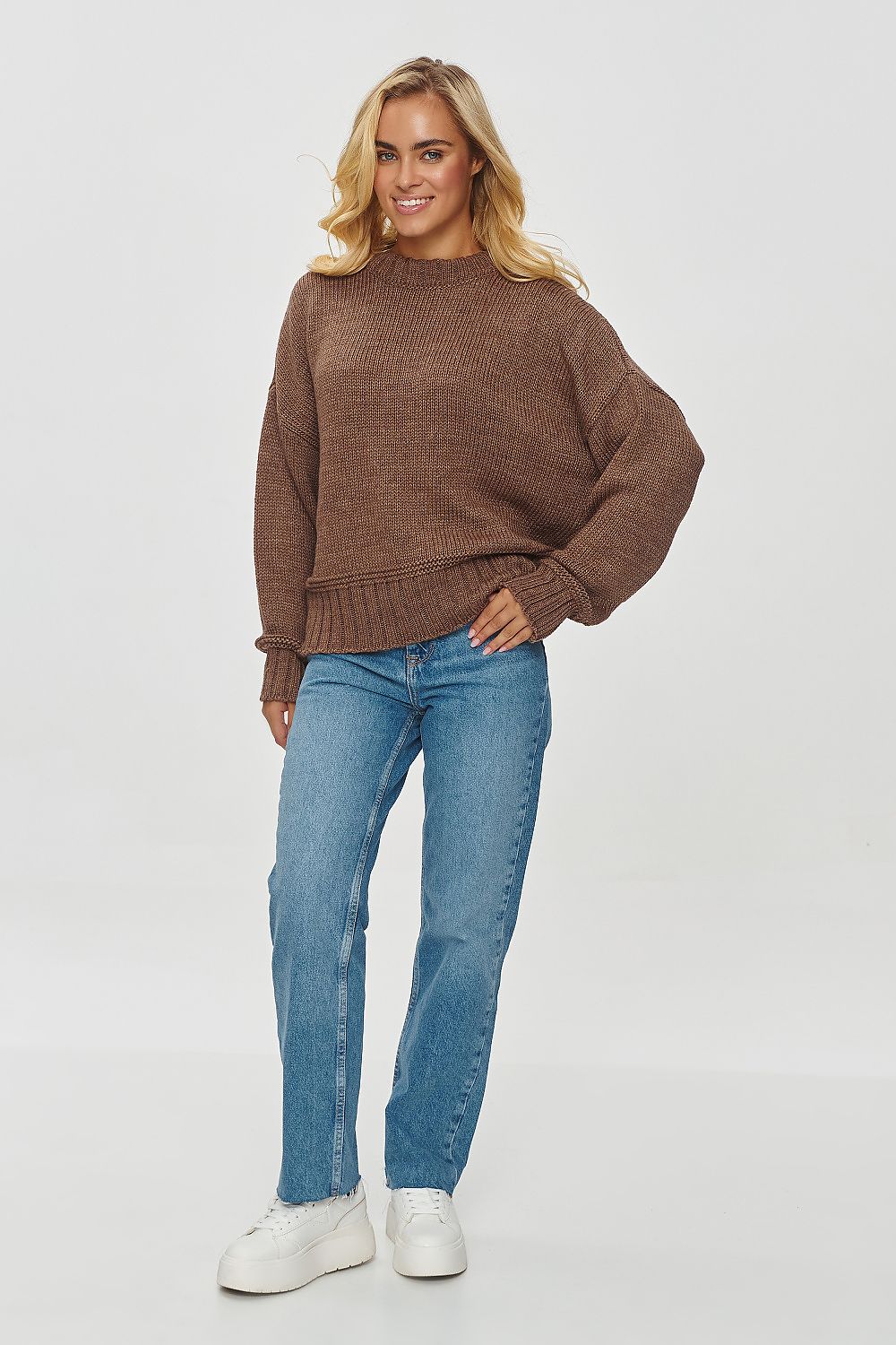 Luxury women's Makadamia loose fit sweater in soft acrylic blend, showcasing its comfortable boxy design and versatile style options for casual or elegant looks.