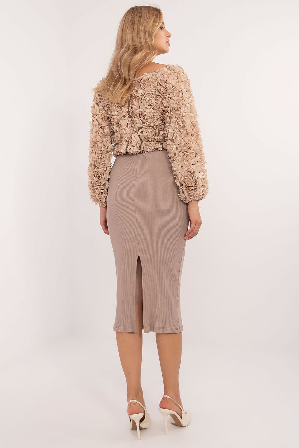 Stylish model wearing the comfortable Relevance midi length ribbed skirt in cotton-spandex blend, embodying effortless elegance for everyday outfits.