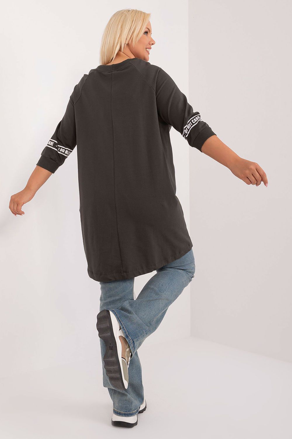 Elegant 3/4 sleeve plus size blouse from Relevance, showcasing a refined round neckline and dynamic asymmetrical design, ideal for sophisticated casual outings.