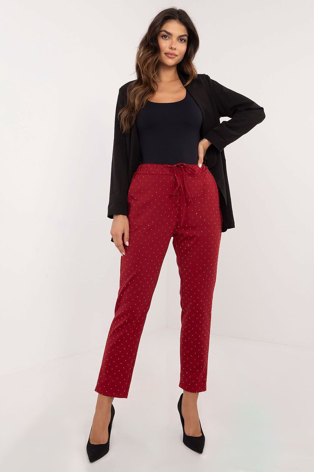 Close-up of Italy Moda's stylish black tracksuit trousers featuring rhinestones, highlighting the luxurious texture and quality craftsmanship.