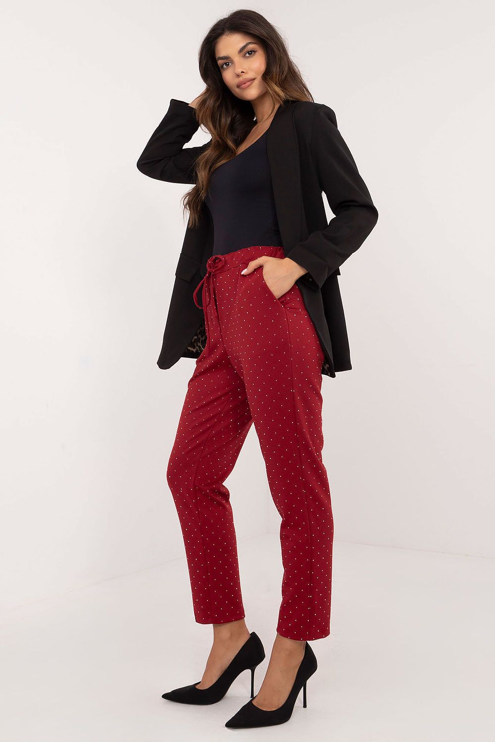 Side view of Italy Moda's elegant black high rise tracksuit trousers adorned with rhinestones, perfect for a chic and comfortable look.
