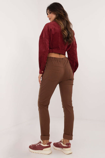 Close-up of Italy Moda's women's glossy fabric trousers, highlighting the soft viscose blend and sophisticated waist tie for a custom fit.