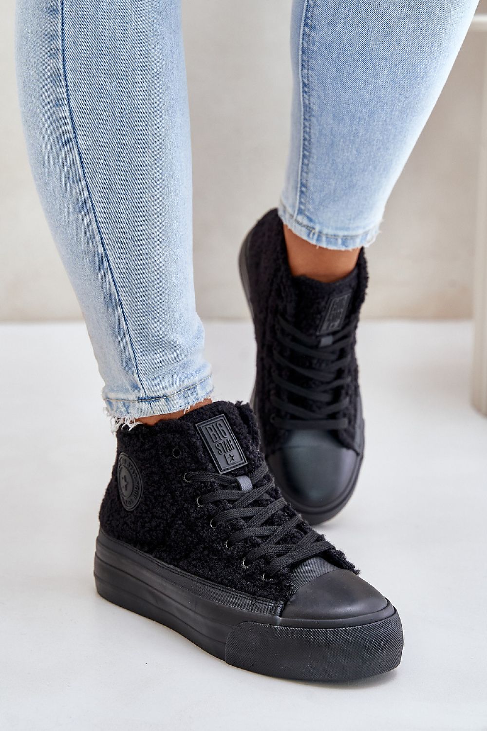 Chic black sheepskin sneakers by BIG STAR, designed with a rounded toe and insulated interior for warmth, ideal for cold weather.
