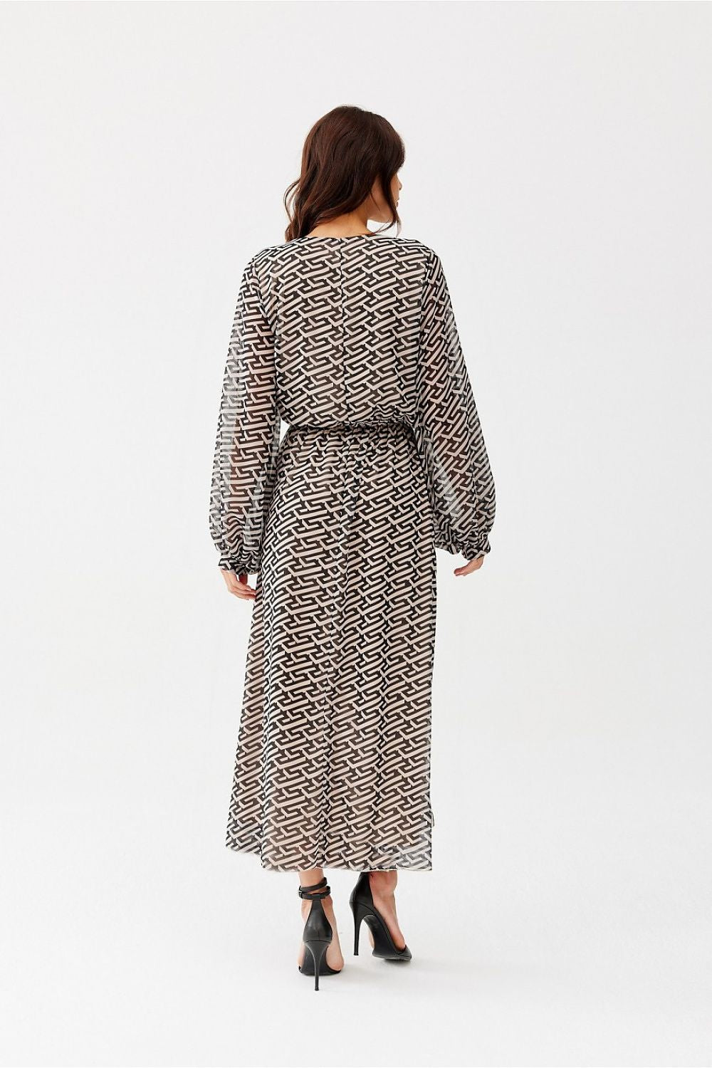 The Ariela Long Chiffon Dress by Roco Fashion displayed on a model, highlighting the flattering semi-sheer sleeves and elastic waistband that provides an exquisite hourglass silhouette.