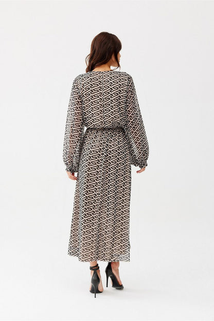 The Ariela Long Chiffon Dress by Roco Fashion displayed on a model, highlighting the flattering semi-sheer sleeves and elastic waistband that provides an exquisite hourglass silhouette.