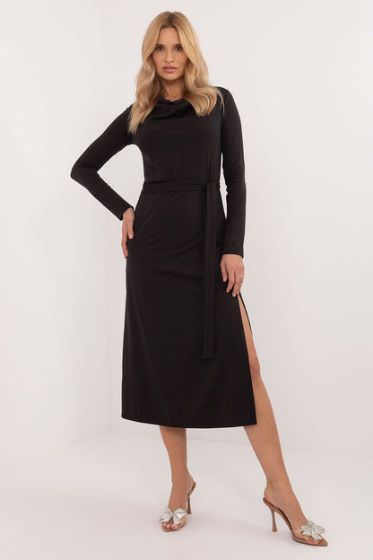 Woman wearing the Lakerta Midi Dress, styled for a sophisticated office look with a flowing neckline and waist-tie belt accentuating the figure.