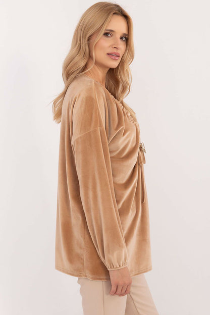 Close-up of the Italy Moda Women's velour blouse showcasing decorative creasing and a detachable butterfly tag, embodying luxurious comfort.