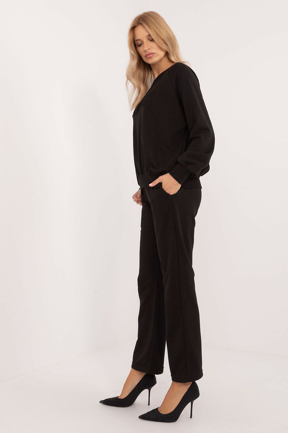 Close-up of the elegant sweatshirt from the luxury women's tracksuit set by Factory Price, showcasing its smooth fabric and original design.