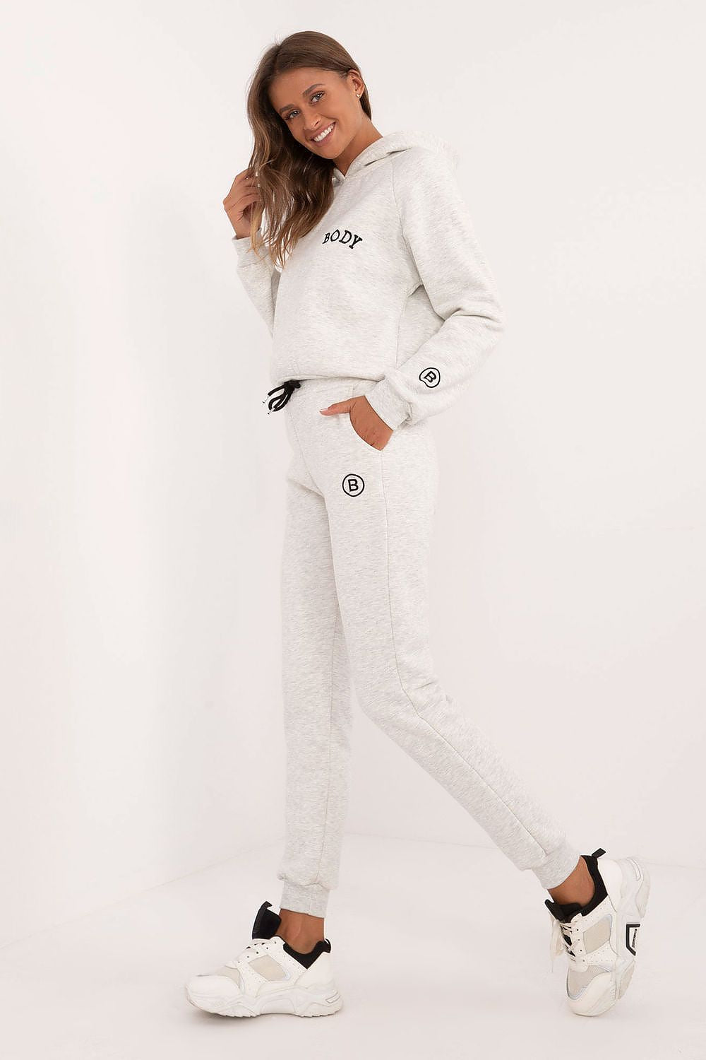 Elegant women's cotton-polyester melange lounge set, showcasing a comfortable sweatshirt with hood and high-waisted pants, designed for warmth and sophistication by Factory Price.