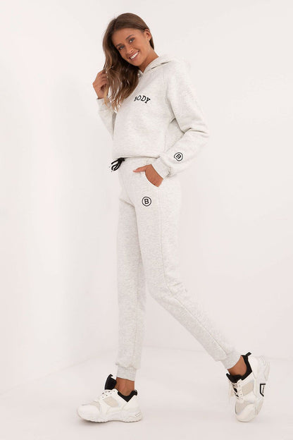 Elegant women's cotton-polyester melange lounge set, showcasing a comfortable sweatshirt with hood and high-waisted pants, designed for warmth and sophistication by Factory Price.