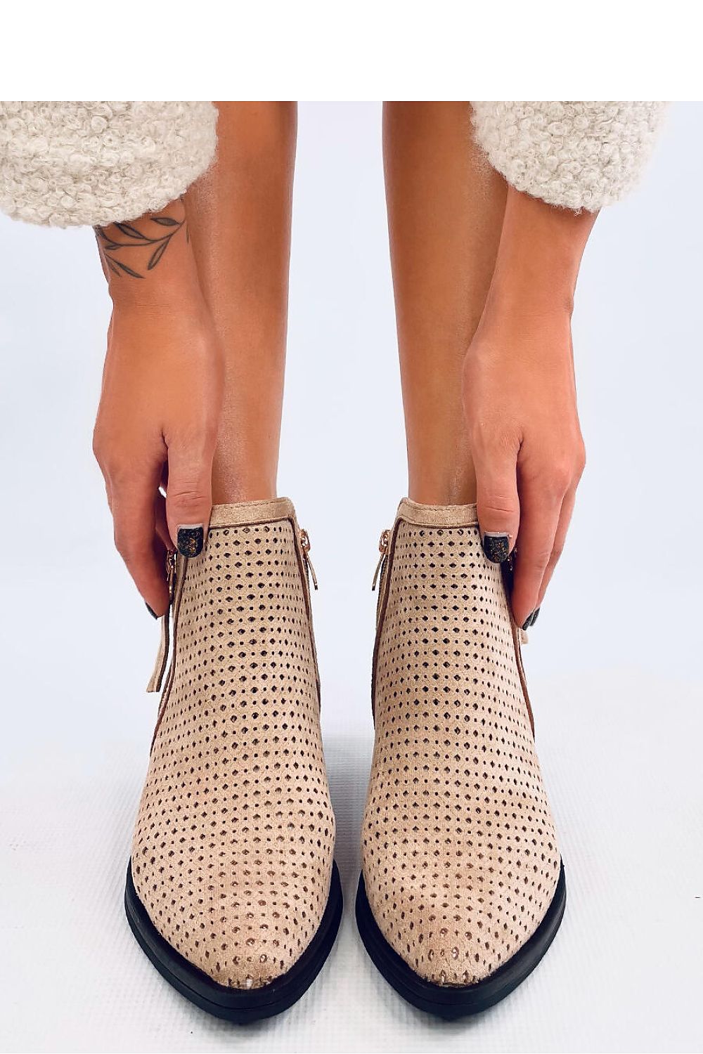 Elegant women's suede ankle boots from Inello, showcasing trendy cutouts and a comfortable 5cm heel, perfect for stylish outfits.