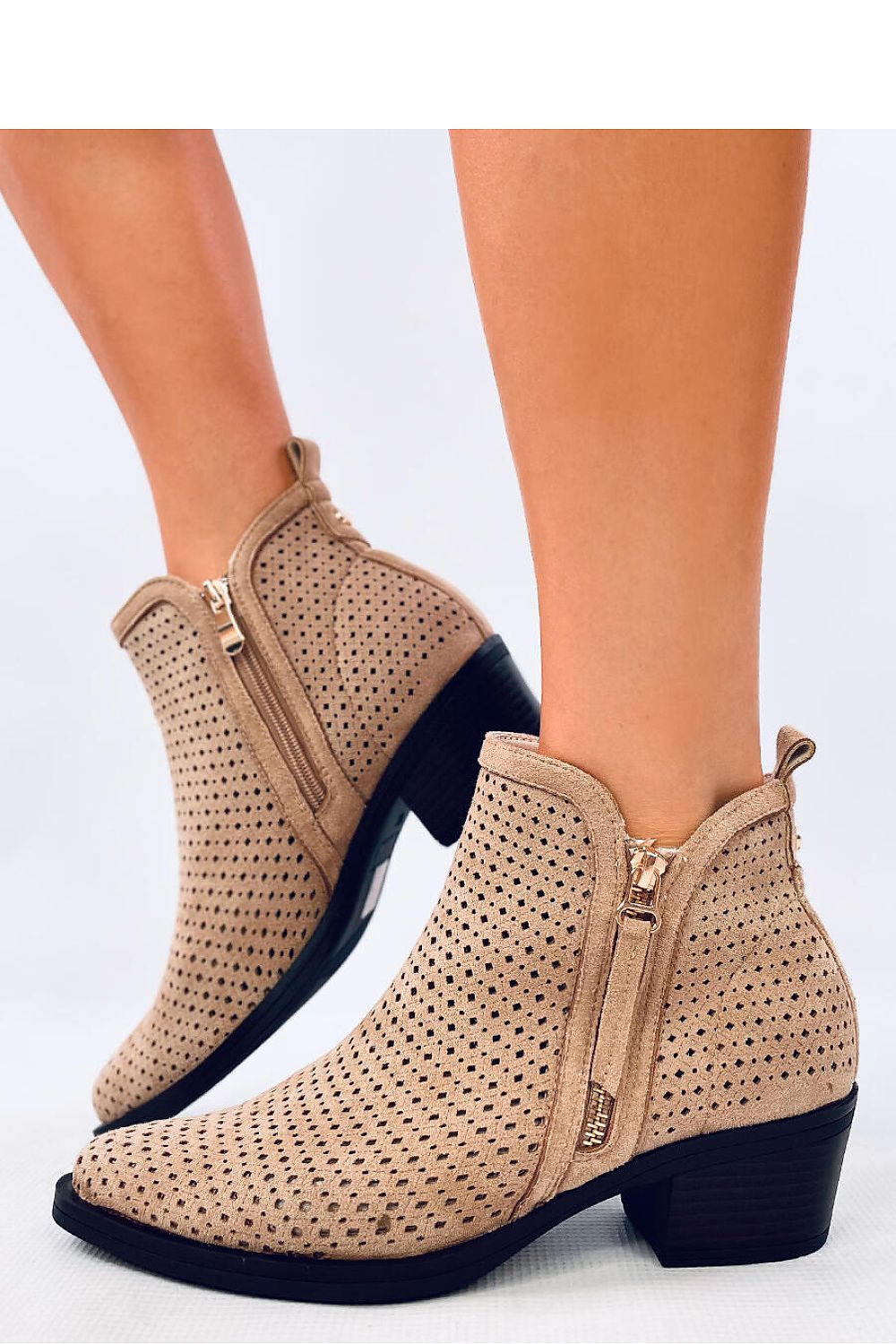 Elegant women's suede ankle boots by Inello, showcasing a stylish cowboy design with chic cutouts and a comfortable 5cm heel, perfect for sophisticated outfits.