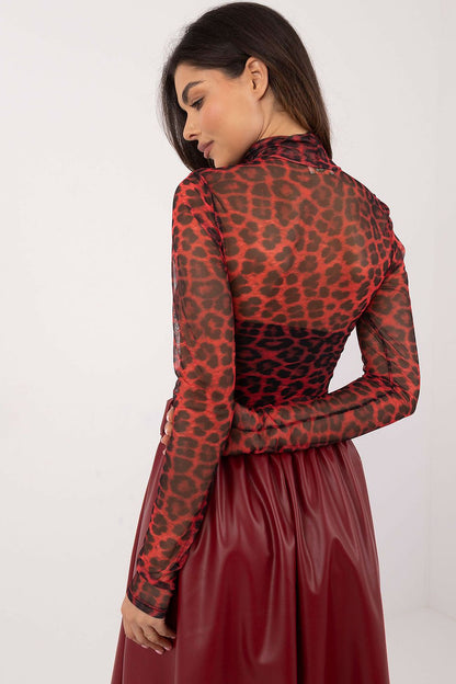 Model wearing the Italy Moda animal print mesh blouse, accentuating a fitted silhouette while displaying the intricate see-through details.