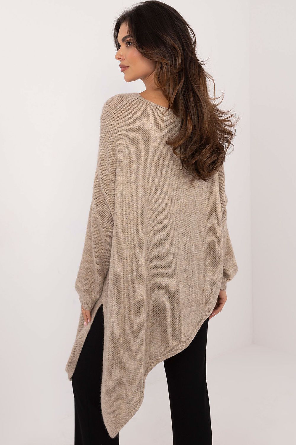 Detailed view of the asymmetrical hem of Och Bella Women’s Sweater, exemplifying contemporary fashion and versatile styling options.