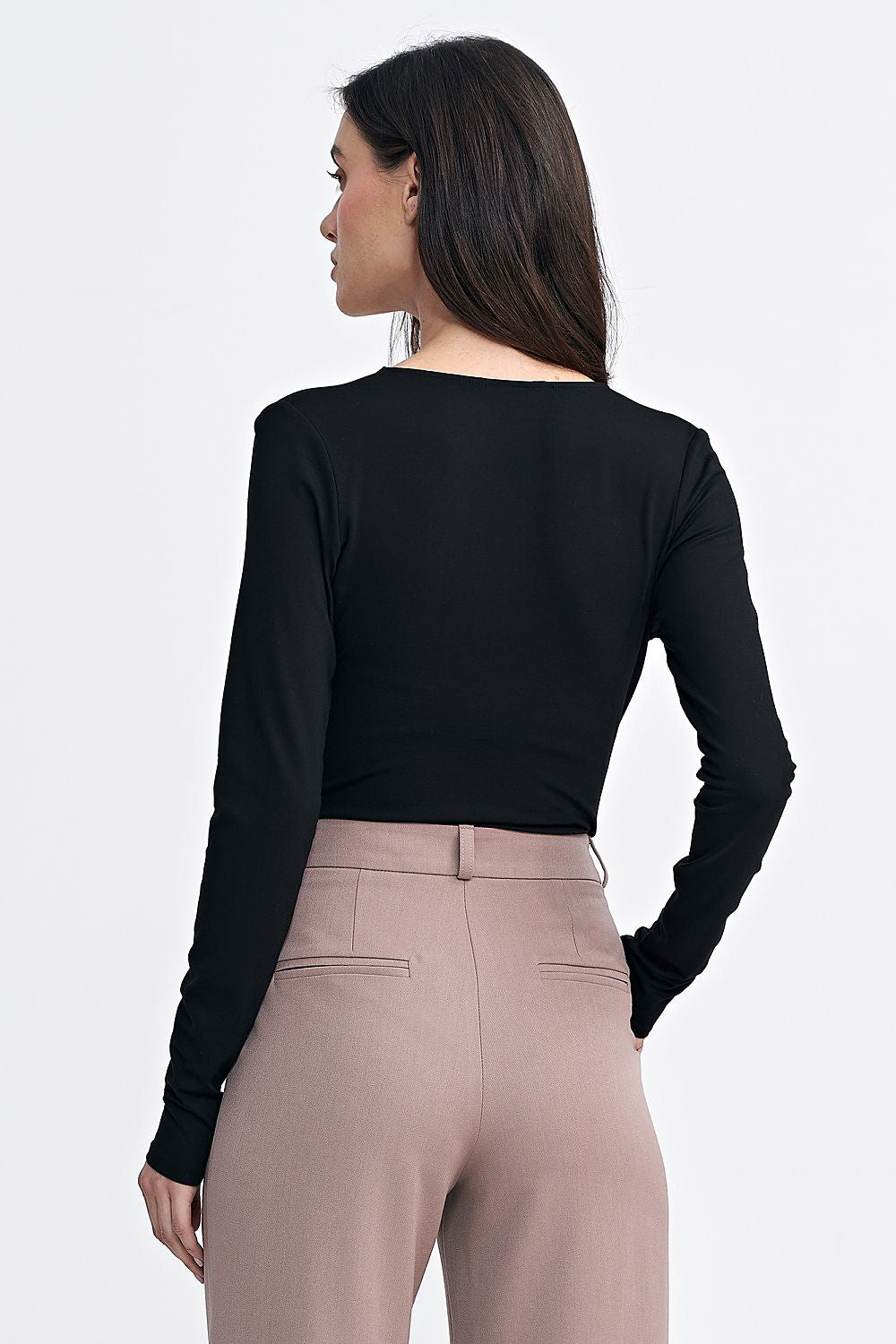 Detailed image of the Nife bodysuit's snap closure and slim sleeves, demonstrating its elegant and functional design.