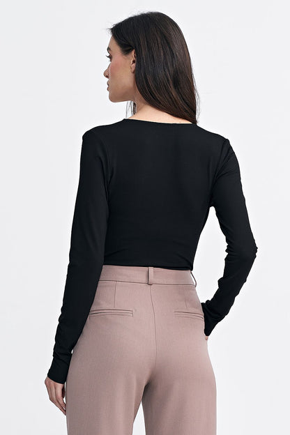 Detailed image of the Nife bodysuit's snap closure and slim sleeves, demonstrating its elegant and functional design.