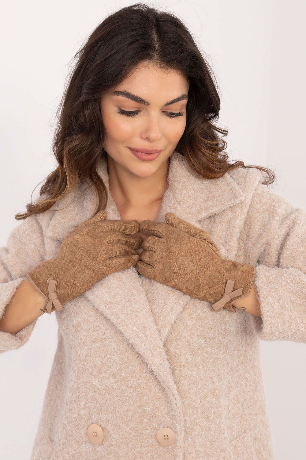 Chic and elegant warm women's gloves by AT, showcasing decorative bow accents and practical touchscreen functionality.