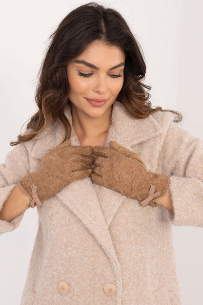 Chic and elegant warm women's gloves by AT, showcasing decorative bow accents and practical touchscreen functionality.