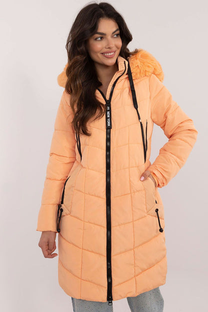 Model wearing a luxury knee-length quilted jacket with a detachable fur hood, exemplifying versatile winter fashion by Factory Price.