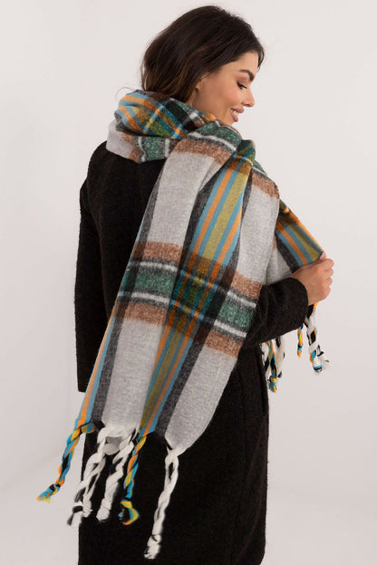 Beautifully styled winter look featuring AT's elegant check pattern polyester scarf with tassels.