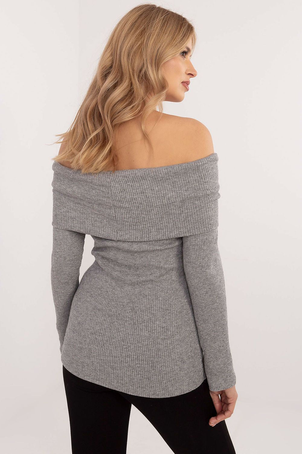 Model wearing Italy Moda's Elegant Off-The-Shoulder Women's Sweater, emphasizing the feminine silhouette and stylish shoulder exposure.