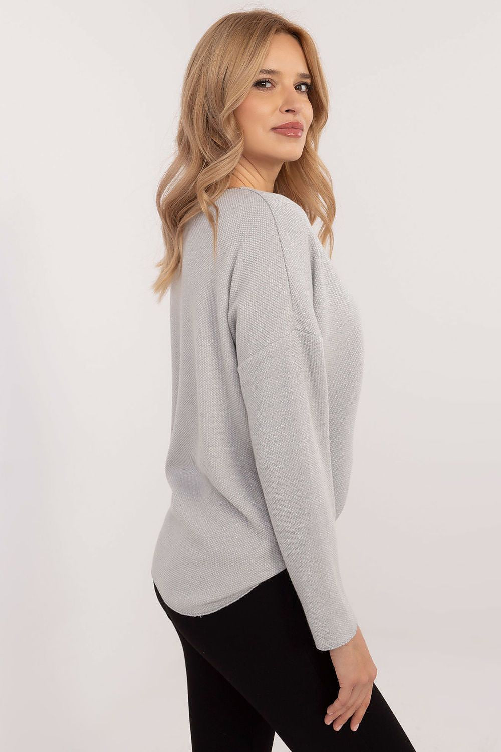 Model wearing Italy Moda's stylish women's V-neck sweater, featuring a flattering silhouette and elegant design, ideal for both casual and formal occasions.