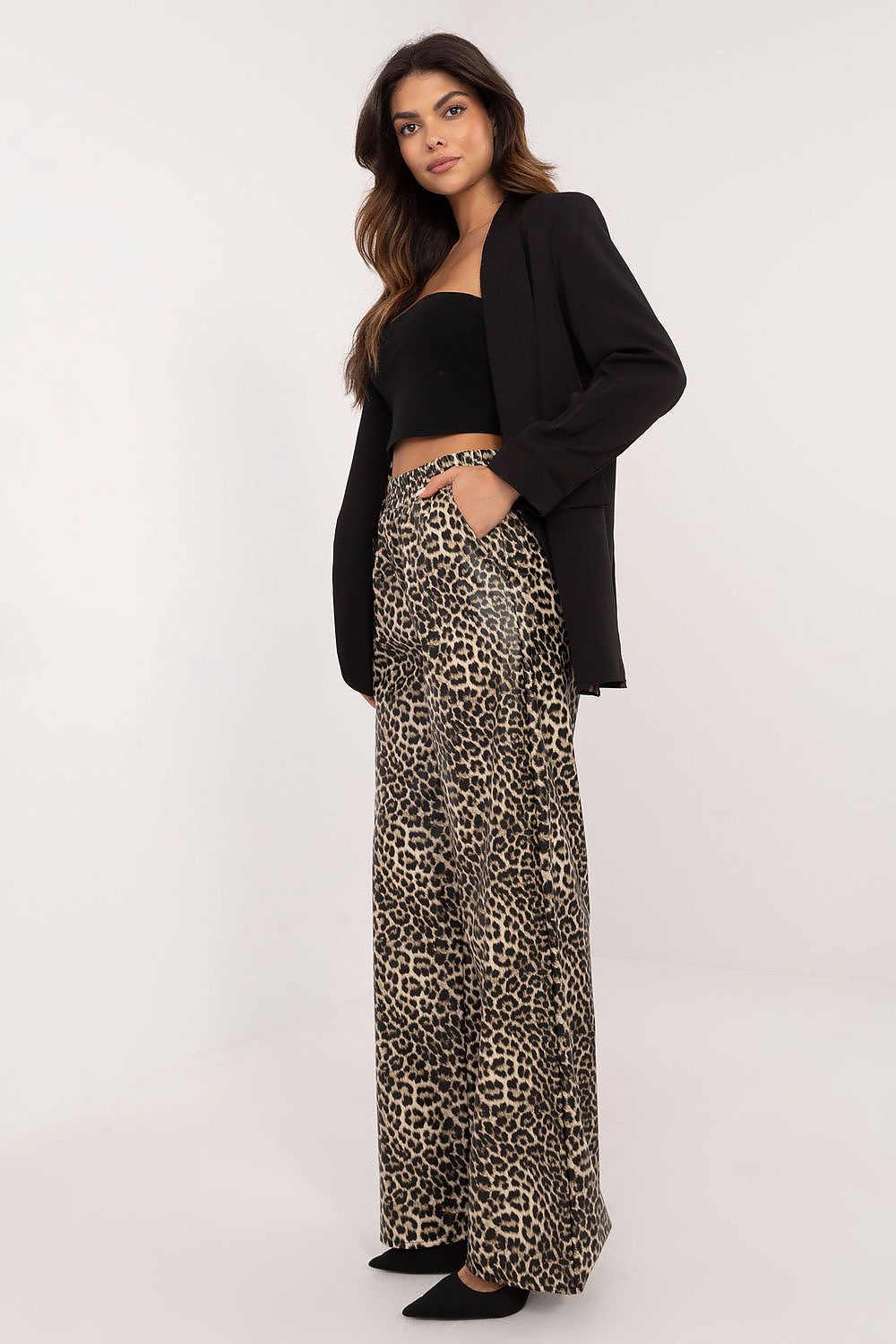 Stylish Lakerta eco-leather women's trousers with a contemporary animal design, high waist silhouette, and practical side pockets, perfect for sophisticated everyday wear.