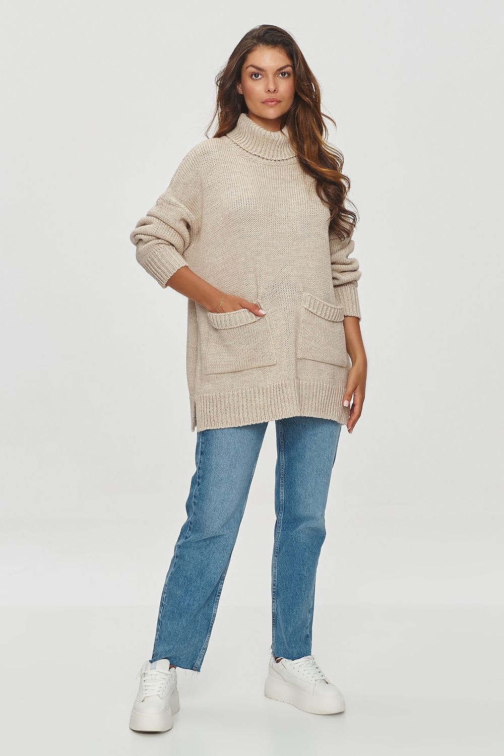 Elegant patch pockets detail on the Makadamia turtleneck sweater, emphasizing functionality and style for modern women.