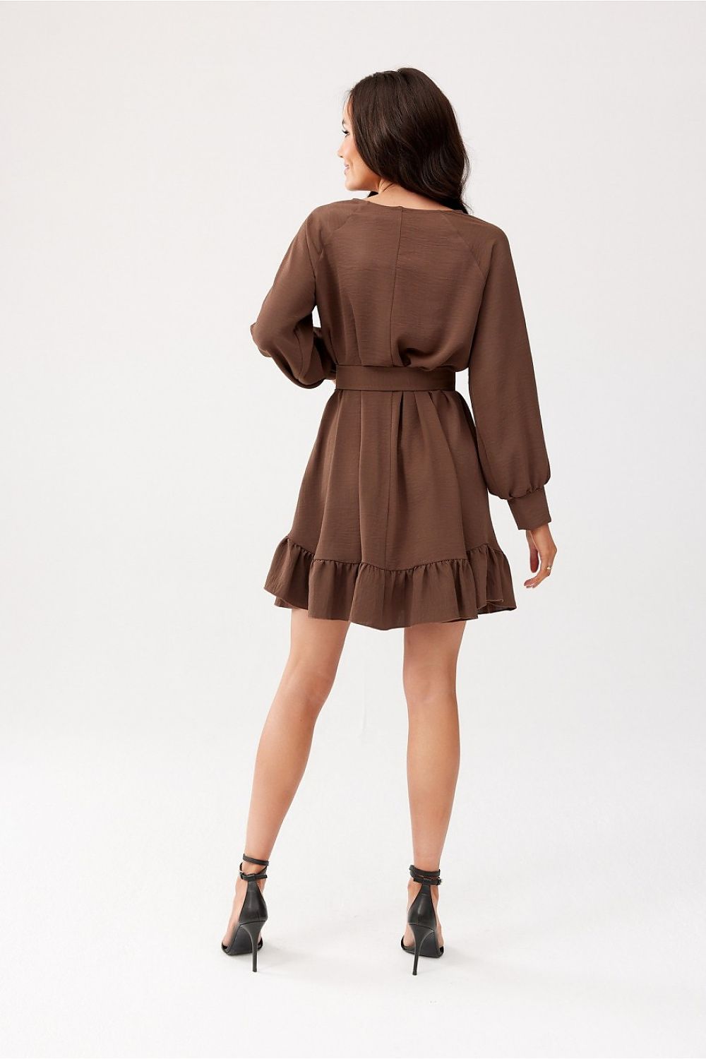 Close-up of the ruffled hem and long sleeves of the Sintra dress by Roco Fashion, showcasing the exquisite craftsmanship.