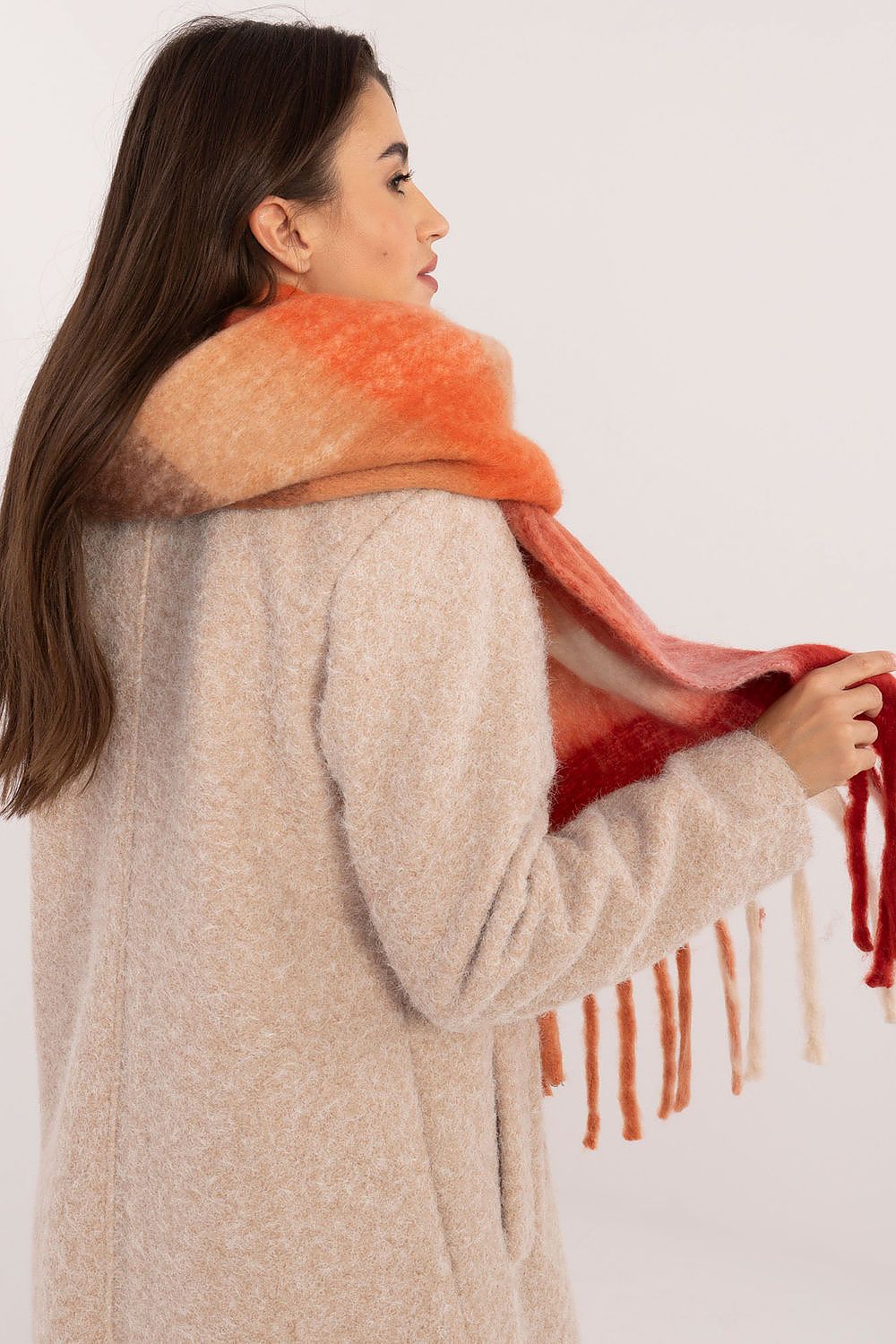AT stylish polyester scarf with classic check pattern, displayed on a model, demonstrating versatility in winter fashion.