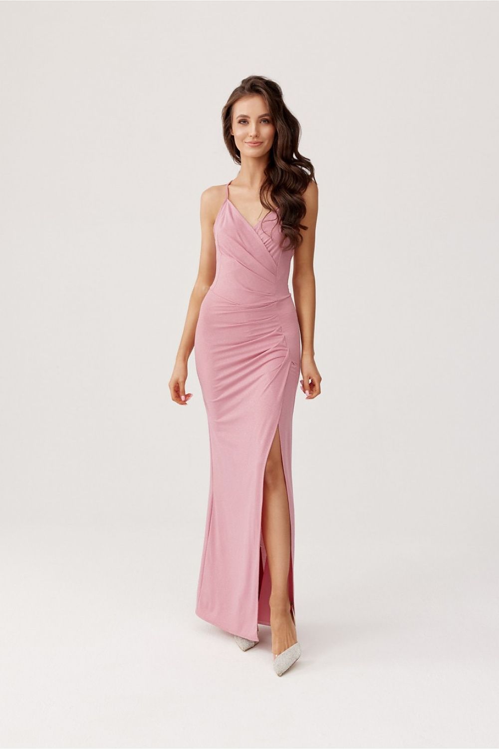 Roco Fashion's luxurious maxi dress with an alluring leg slit and dramatic open back, perfect for elegant evening wear.