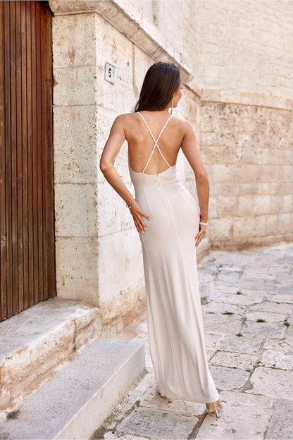 Model wearing the Elegant Open Back Long Strapless Maxi Dress by Roco Fashion, displaying the alluring leg slit and elegant layered neckline.