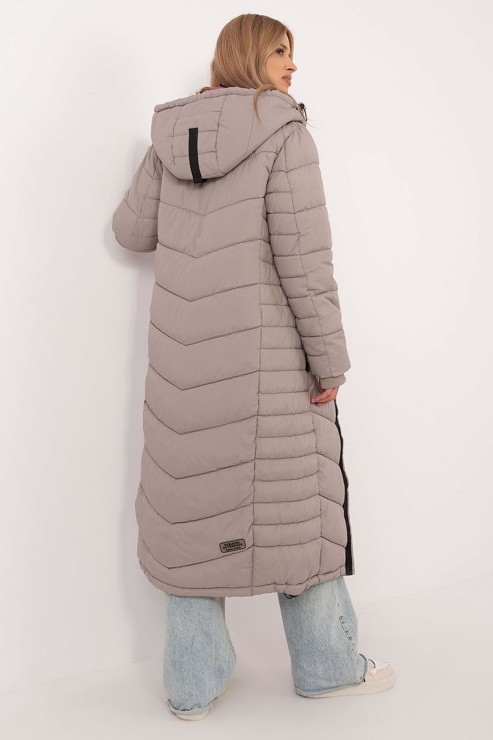 Stylish Sublevel long coat with zippered pockets and a minimalist aesthetic, ideal for fashionable layering in colder weather.