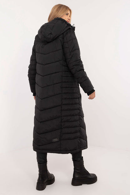 Sublevel women's coat displayed in a casual setting, highlighting its comfortable fit and sophisticated long cut for cold weather.