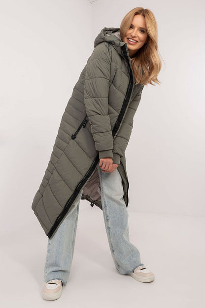 Stylish long coat by Sublevel in an autumn landscape, emphasizing its warmth, functionality, and contemporary style for chic women.