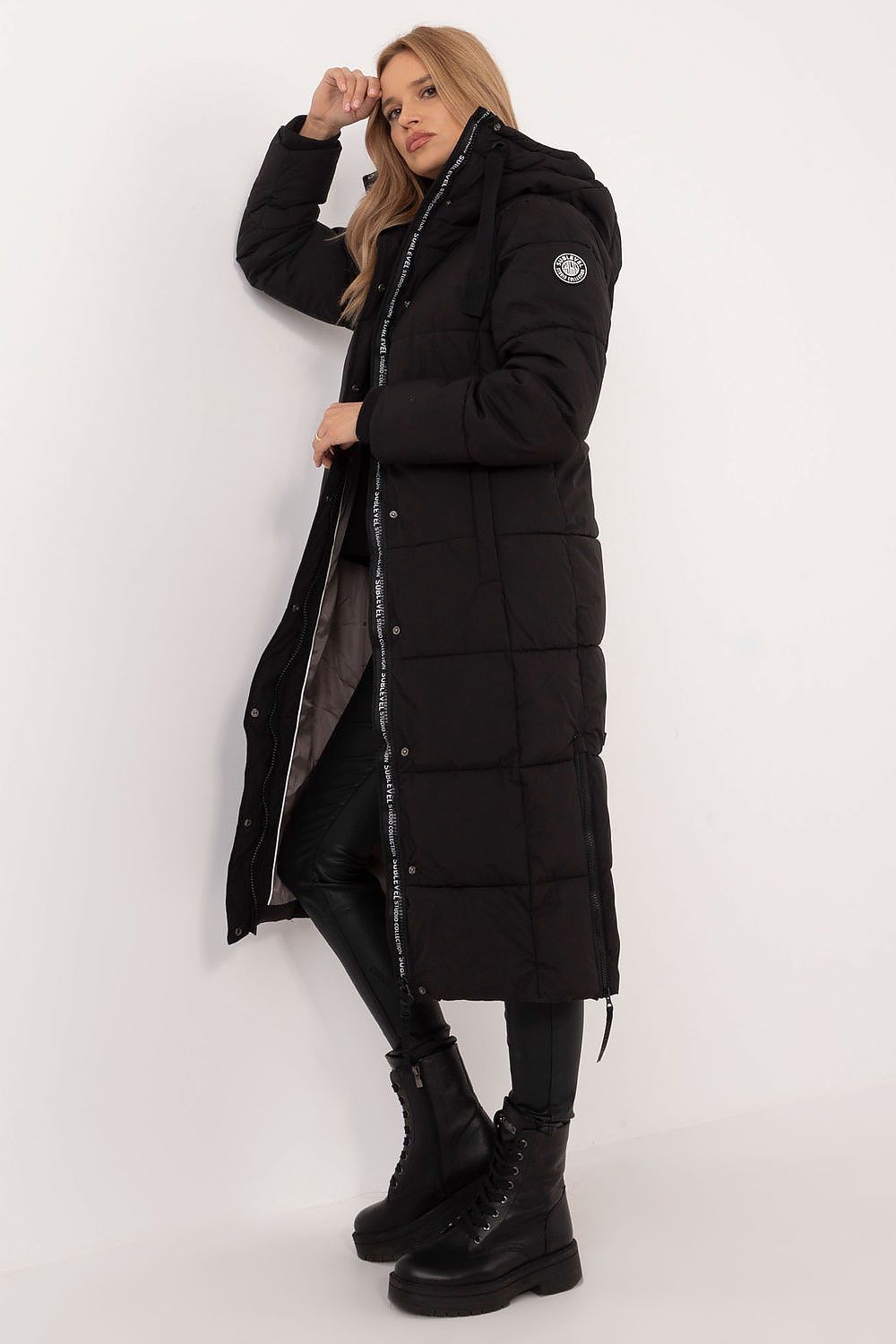 Elegant long women's coat by Sublevel, featuring a stylish casual design with a functional hood, perfect for autumn and winter wear.