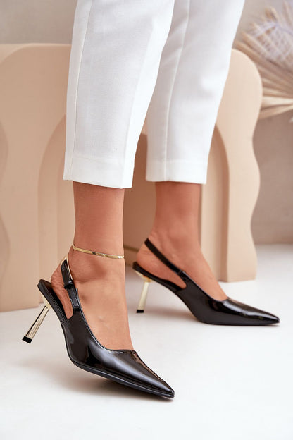 Model wearing elegant gold stiletto heels from Step in Style, illustrating their perfect complement to evening and cocktail outfits.