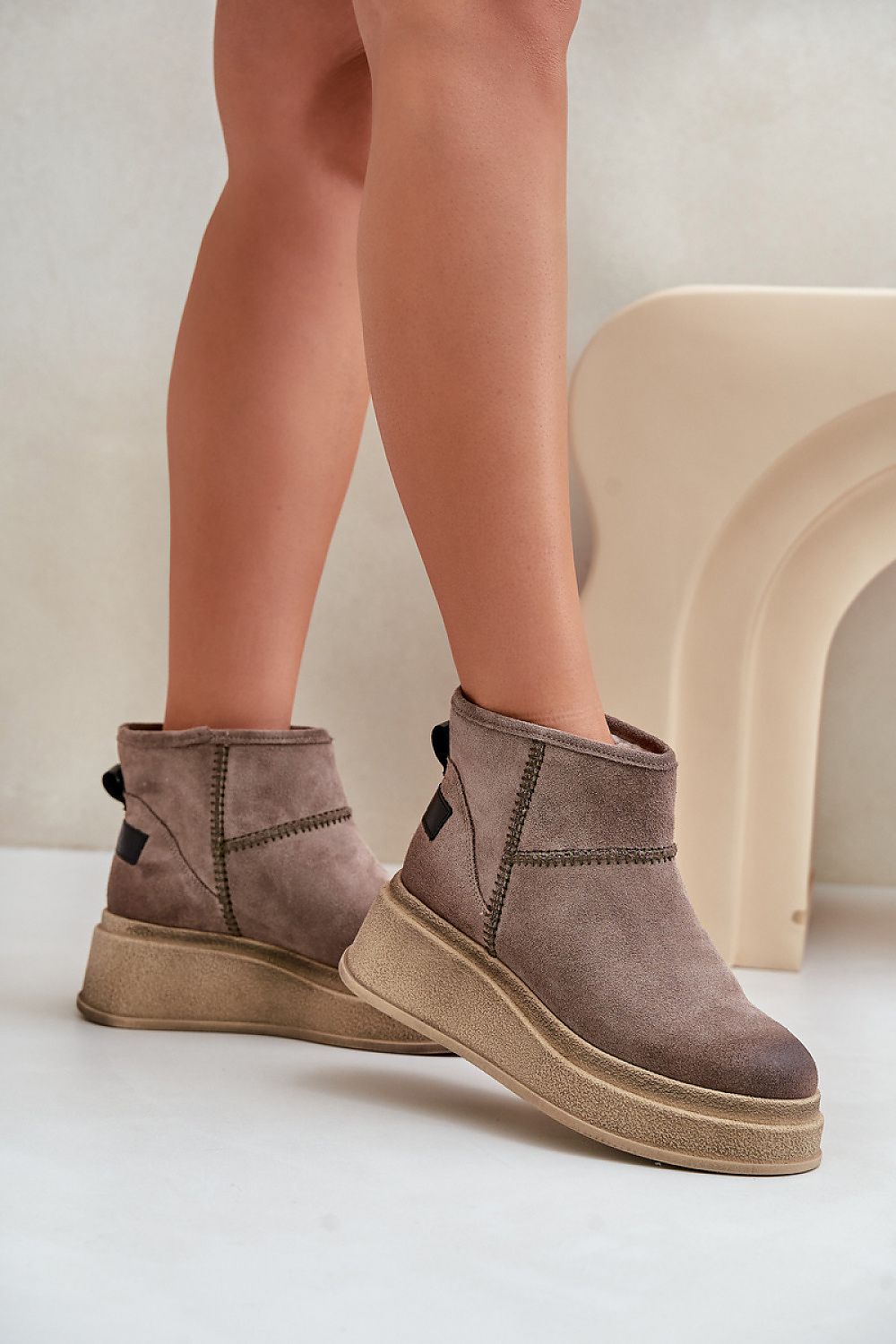 Close-up of Step in Style's luxury women's snow boots showcasing the high-quality suede leather, soft fur lining, and chic wedge heel, perfect for winter styling.