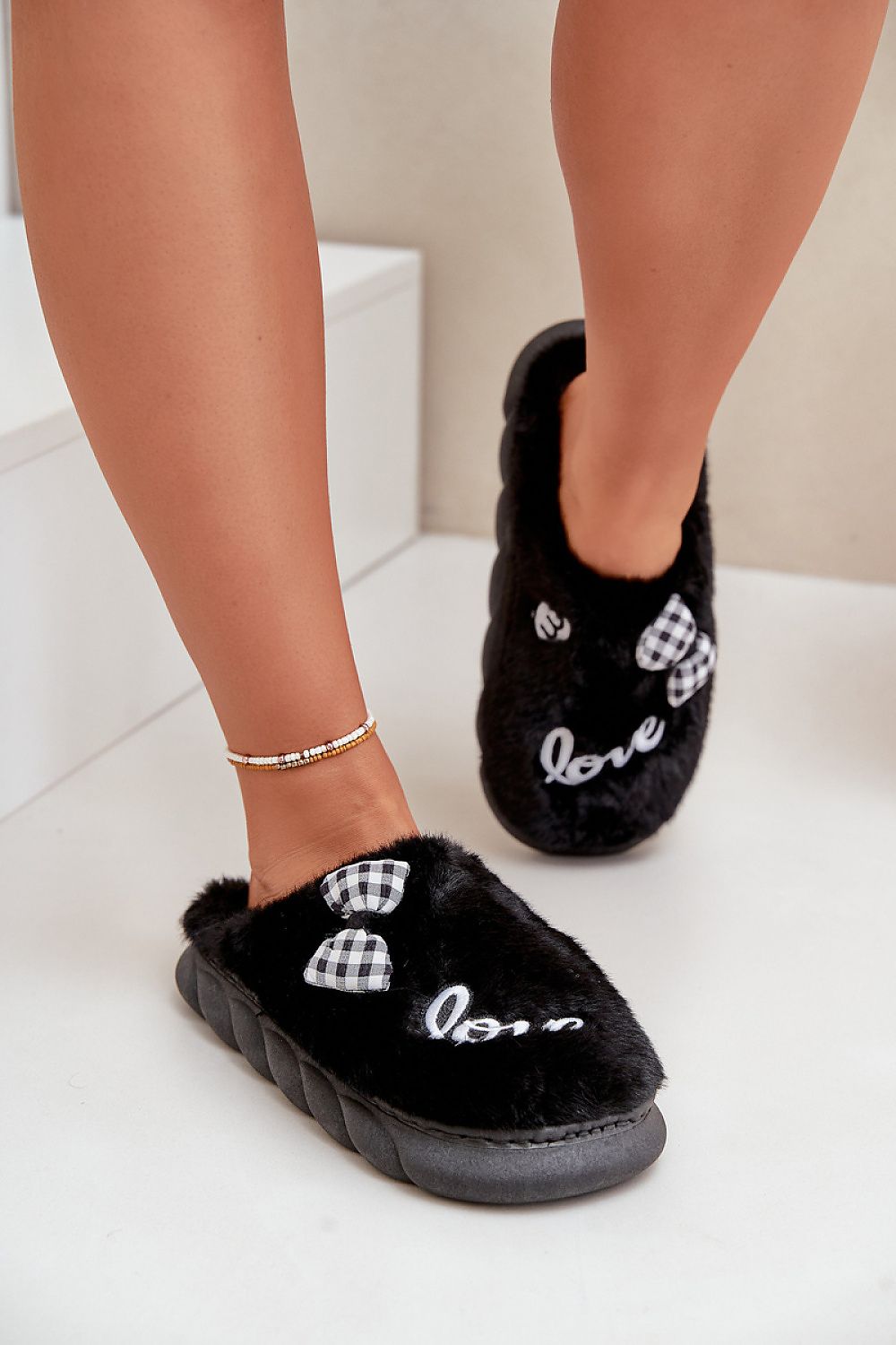 Stylish luxury women's slippers with a chic design of patches and a bow, perfect for colder days, by Step in Style.