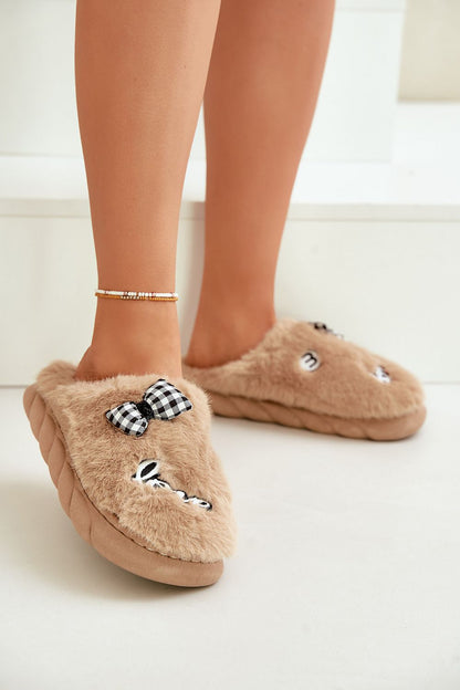 Chic luxury fur slippers for women by Step in style, crafted with plush fur and adorned with fashionable patches and a bow.