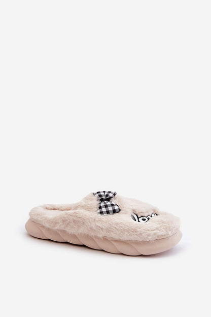 Step in Style's luxurious women's fur slippers with eye-catching patches and bow detailing, showcasing both elegance and warmth.