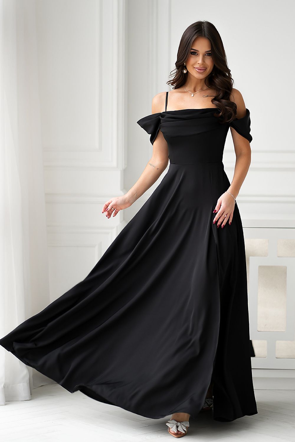Elegant long maxi dress by Bicotone featuring a side slit and drooping straps, perfect for a luxurious and feminine silhouette. Available in EU sizes 34-42.